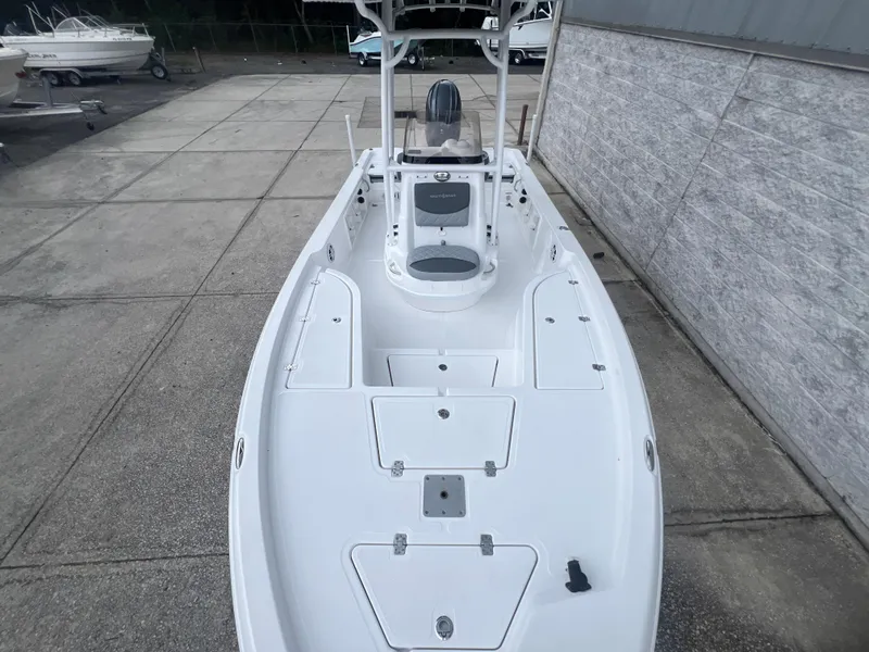 Slide: The Image of 2025 NauticStar 214 Shallow Bay boat, white deck, parked outdoors. - 24