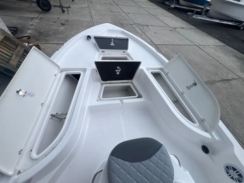 Slide: The Image of 2025 NauticStar 214 Shallow Bay boat interior with open storage compartments. - 25
