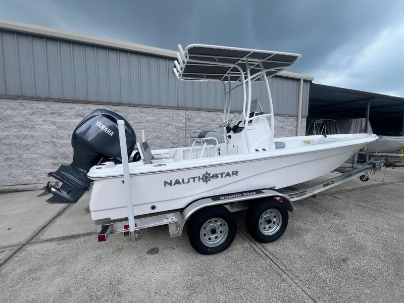 Slide: The Image of 2025 NauticStar 214 Shallow Bay boat on trailer, featuring Yamaha outboard motor. - 3