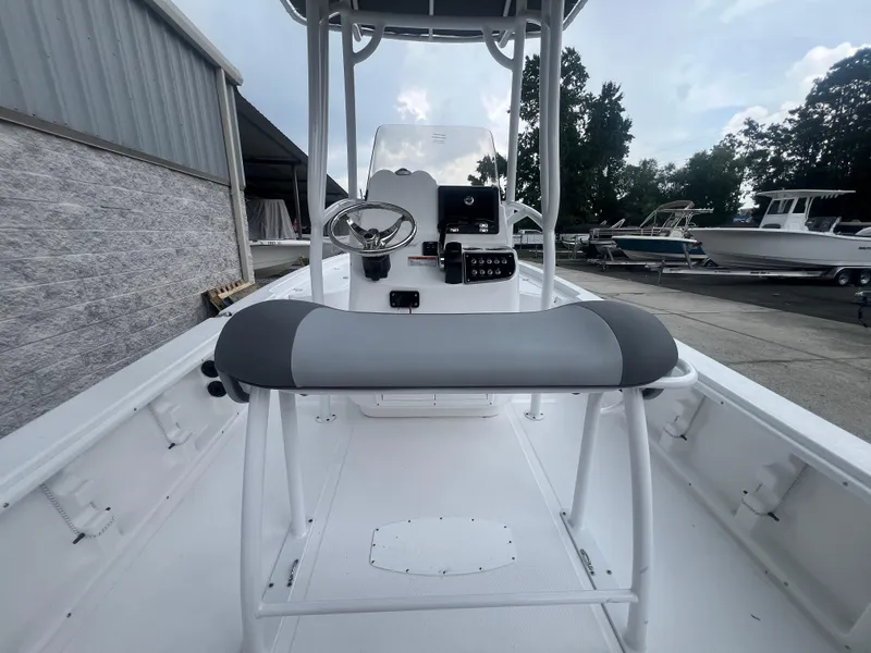 Slide: The Image of 2025 NauticStar 214 Shallow Bay boat interior with steering console and seating. - 9