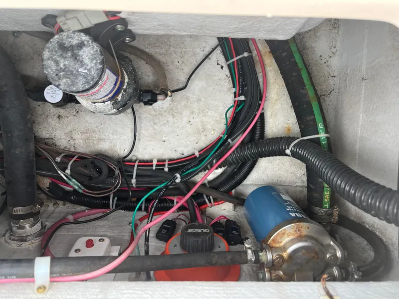 Slide: The Image of Electrical and plumbing components inside a 2013 Grady-White 22 Seafarer boat. - 11