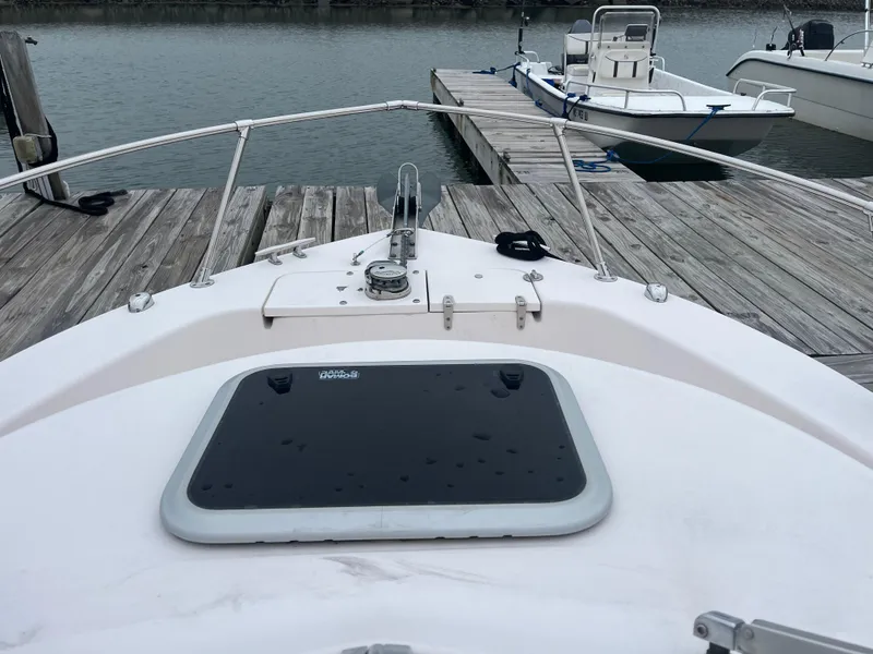 Slide: The Image of 2013 Grady-White 22 Seafarer boat docked at a wooden pier. - 14