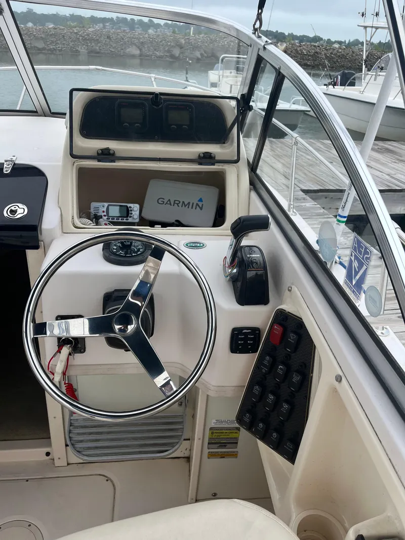 Slide: The Image of Grady-White 22 Seafarer 2013 boat cockpit with steering wheel and Garmin navigation system. - 17