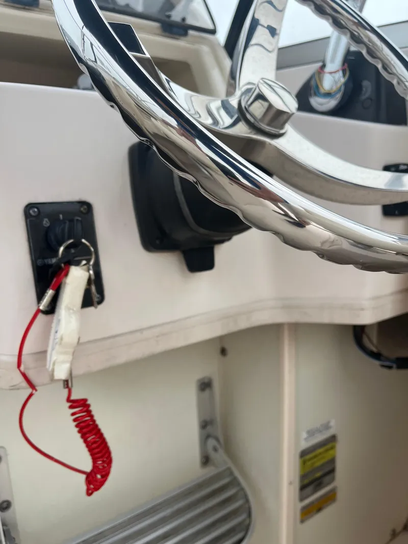 Slide: The Image of Steering wheel and ignition of 2013 Grady-White 22 Seafarer boat. - 18