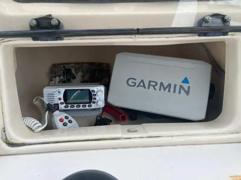 Slide: The Image of Storage compartment on 2013 Grady-White 22 Seafarer with Garmin equipment and radio. - 23