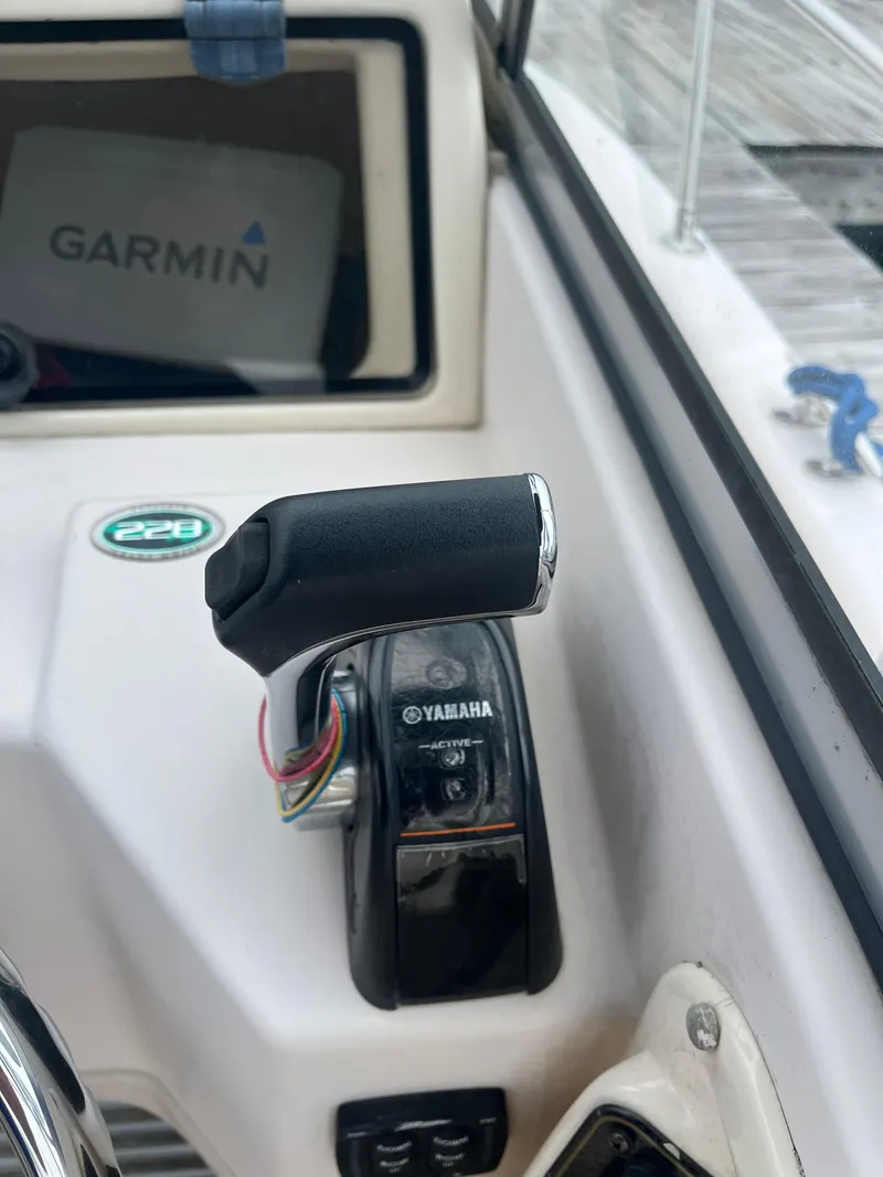 Slide: The Image of Throttle control on 2013 Grady-White 22 Seafarer boat with Garmin display and Yamaha branding. - 24