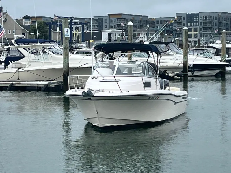 Slide: The Image of 2013 Grady-White 22 Seafarer boat docked in a marina with other vessels. - 3