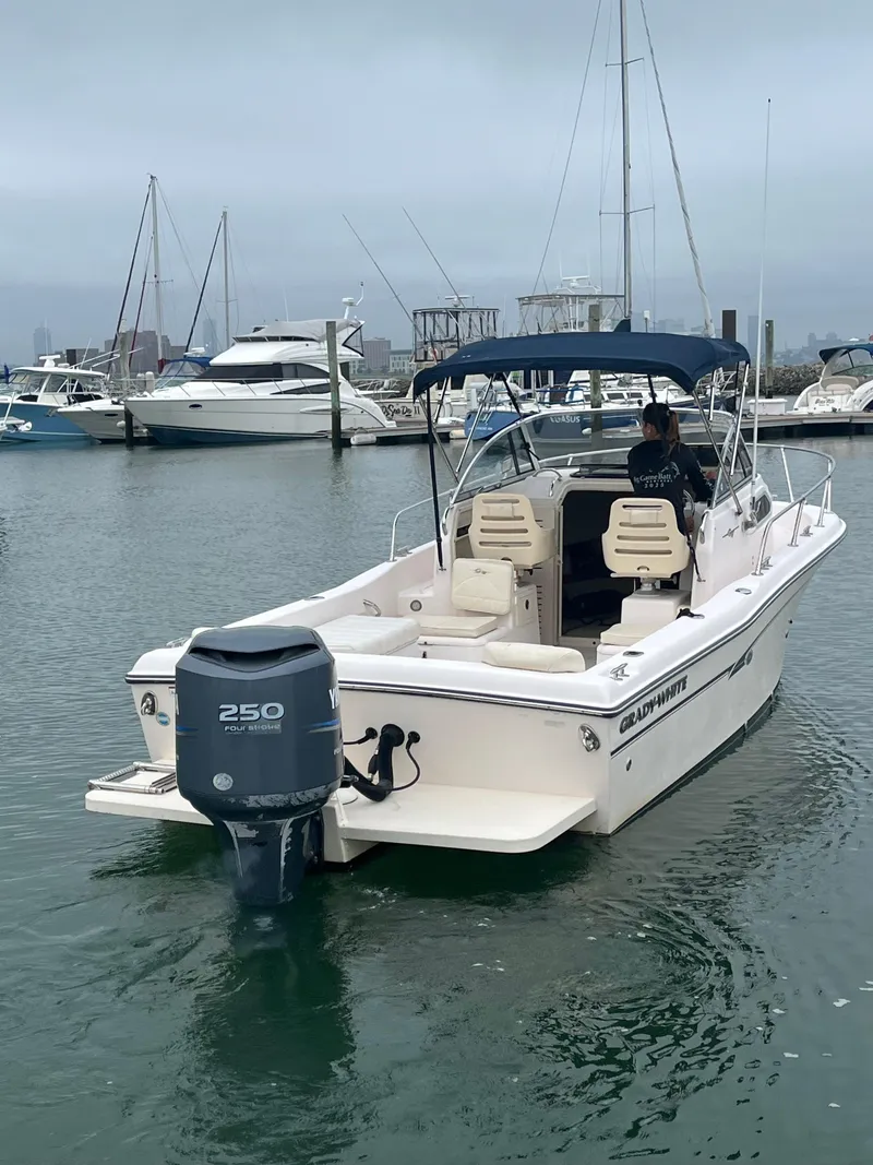 Slide: The Image of 2013 Grady-White 22 Seafarer boat in marina, featuring Yamaha 250 outboard motor. - 5