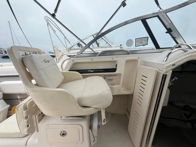 Slide: The Image of Interior of a 2013 Grady-White 22 Seafarer boat, featuring a captain's chair and dashboard. - 7