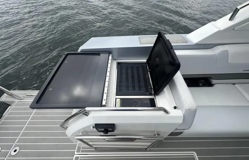 Slide: The Image of Outdoor grill on 2021 Formula 400 Super Sport Crossover yacht deck by the water. - 11