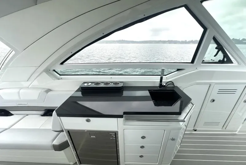 Slide: The Image of Interior of 2021 Formula 400 Super Sport Crossover yacht with sleek kitchenette and panoramic window view. - 14