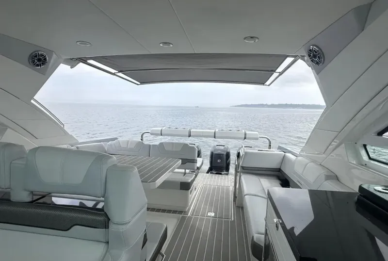 Slide: The Image of 2021 Formula 400 Super Sport Crossover yacht interior with luxurious seating and ocean view. - 16