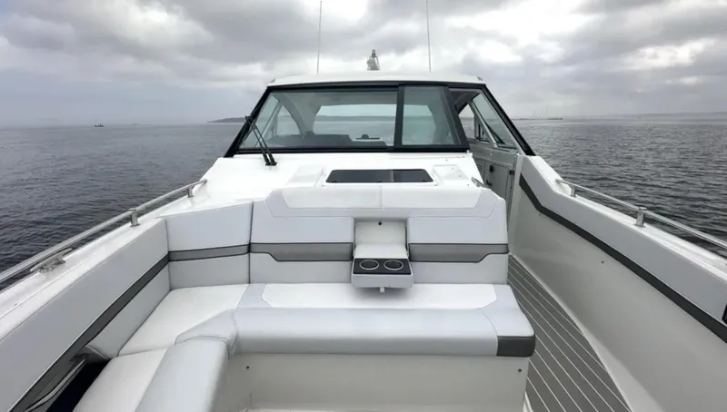 Slide: The Image of 2021 Formula 400 Super Sport Crossover boat on calm water under cloudy skies. - 27