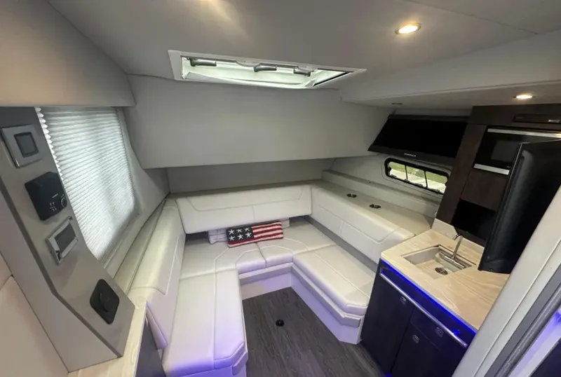 Slide: The Image of 2021 Formula 400 Super Sport Crossover interior with white seating and kitchenette. - 28