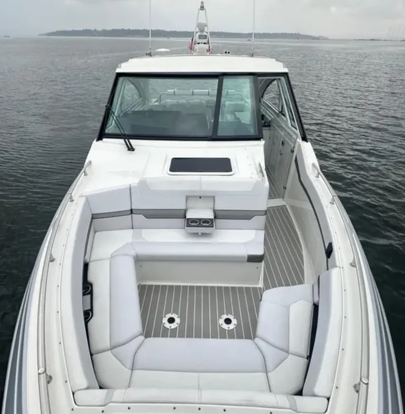 Slide: The Image of 2021 Formula 400 Super Sport Crossover boat with spacious seating on calm water. - 3