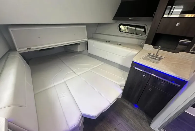 Slide: The Image of 2021 Formula 400 Super Sport Crossover interior with white seating and compact kitchenette. - 30