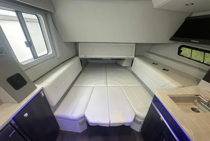 Slide: The Image of Interior of 2021 Formula 400 Super Sport Crossover with white seating and modern amenities. - 31