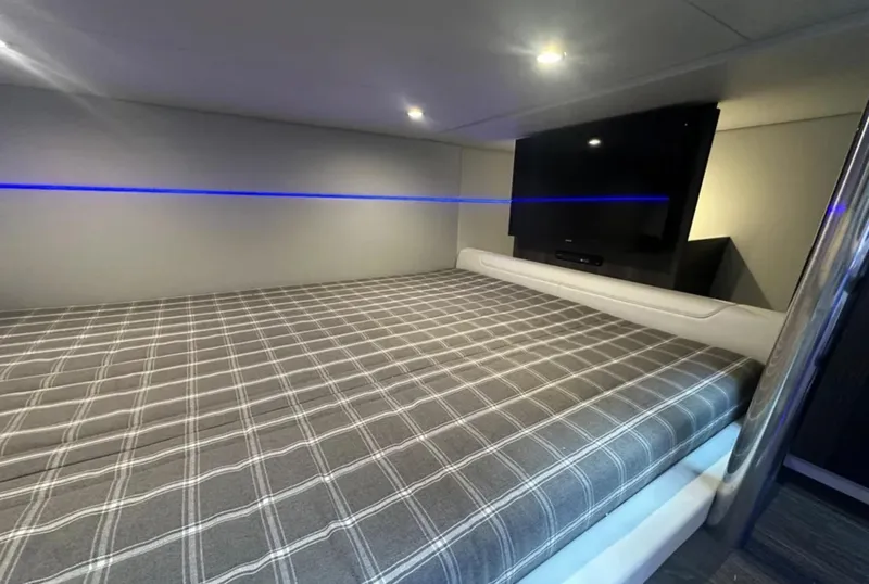 Slide: The Image of Interior cabin of 2021 Formula 400 Super Sport Crossover with plaid bedding and ambient lighting. - 34