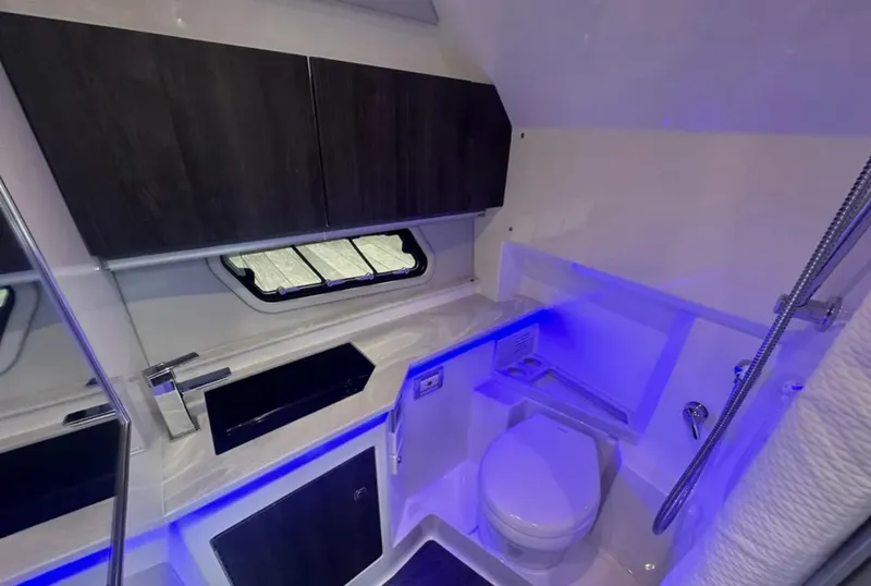 Slide: The Image of Luxurious bathroom in 2021 Formula 400 Super Sport Crossover boat with modern fixtures and blue lighting. - 35