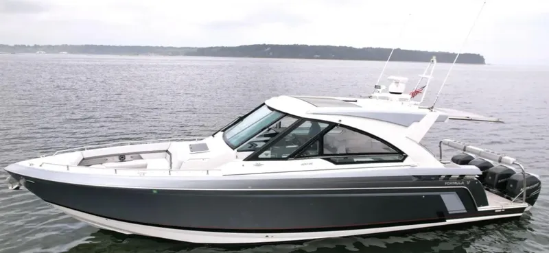 Slide: The Image of 2021 Formula 400 Super Sport Crossover boat on calm water, side view. - 4
