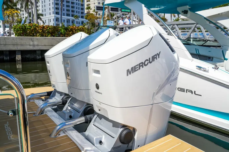 Slide: The Image of 2026 Regal 50 SAV boat with Mercury outboard engines docked at marina. - 27