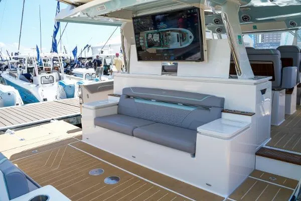 Slide: The Image of Luxurious 2026 Regal 50 SAV yacht interior with seating and TV display at marina. - 30