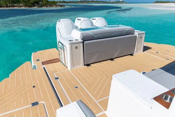 Slide: The Image of 2026 Regal 50 SAV yacht deck with luxurious seating, overlooking turquoise waters. - 43