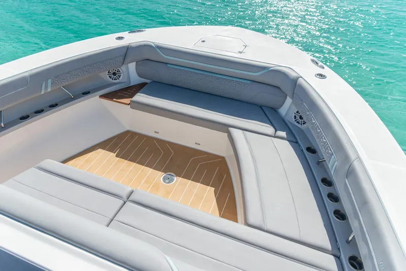 Slide: The Image of Luxurious seating area on 2026 Regal 50 SAV boat with turquoise water backdrop. - 44