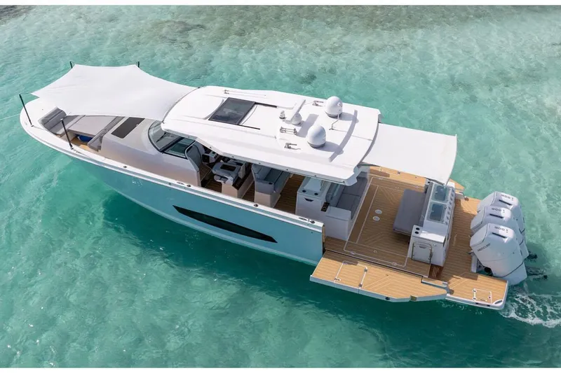 Slide: The Image of 2026 Regal 50 SAV yacht on clear turquoise water, showcasing sleek design and spacious deck. - 5