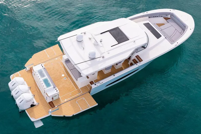 Slide: The Image of 2026 Regal 50 SAV luxury yacht on clear blue water, aerial view. - 8