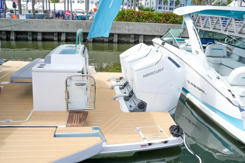 Slide: The Image of 2026 Regal 50 SAV boat with Mercury engines docked at marina. - 9