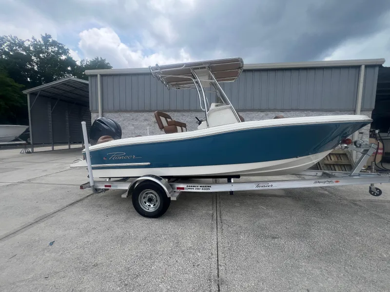 The Image of 2026 Pioneer 202 Islander boat on trailer, blue hull, parked outdoors. - 0