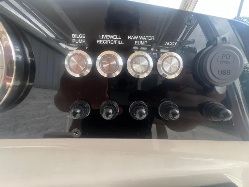 Slide: The Image of Control panel of 2026 Pioneer 202 Islander boat with USB port and pump switches. - 12