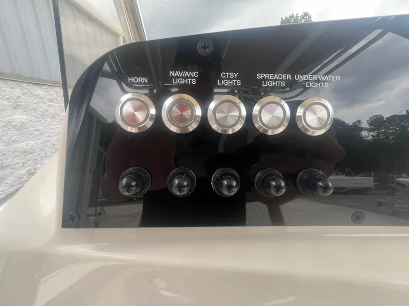 Slide: The Image of Control panel of 2026 Pioneer 202 Islander boat with labeled buttons and switches. - 14
