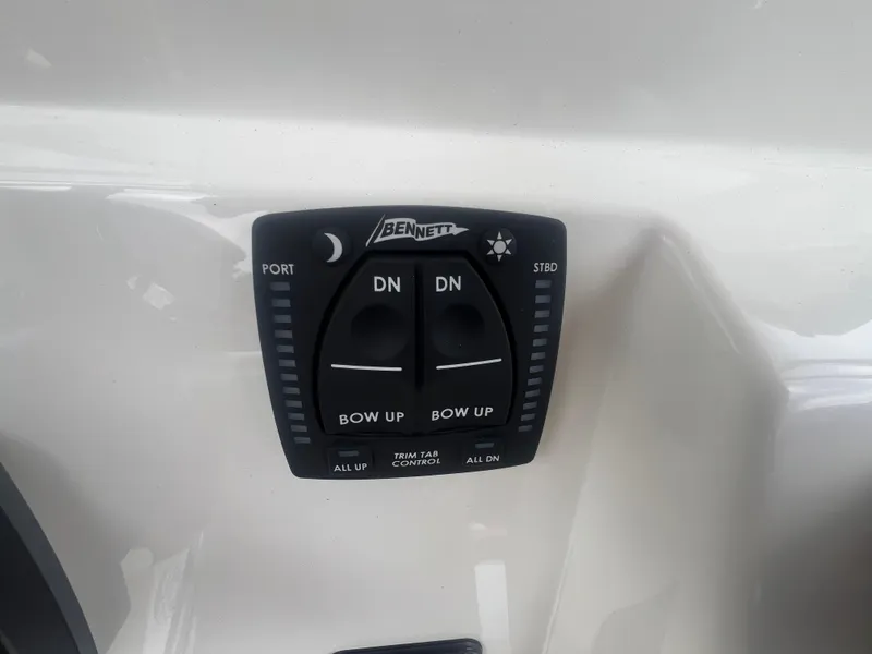 Slide: The Image of Bennett trim tab control on 2026 Pioneer 202 Islander boat dashboard. - 15