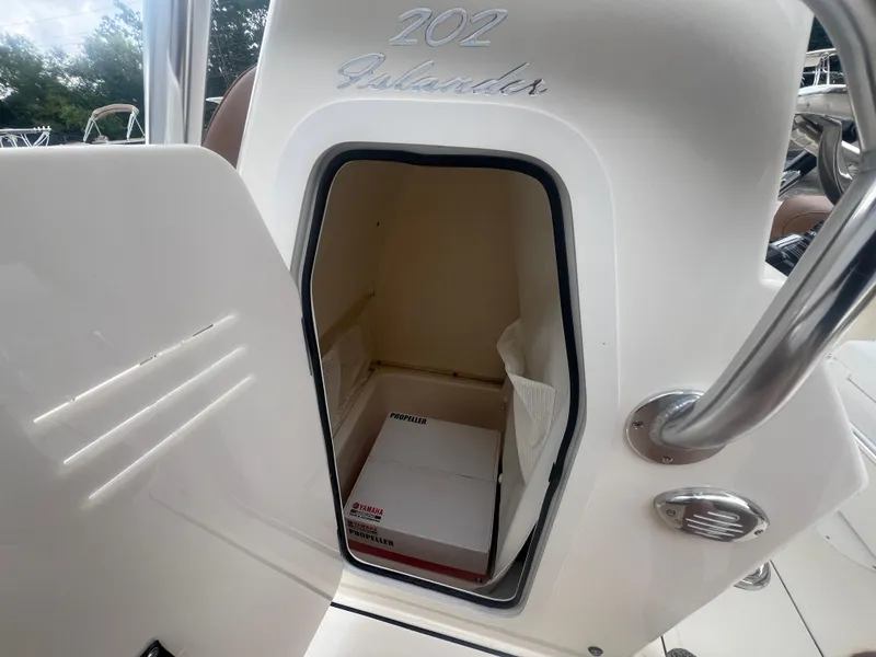 Slide: The Image of 2026 Pioneer 202 Islander boat storage compartment with Yamaha propeller box inside. - 17
