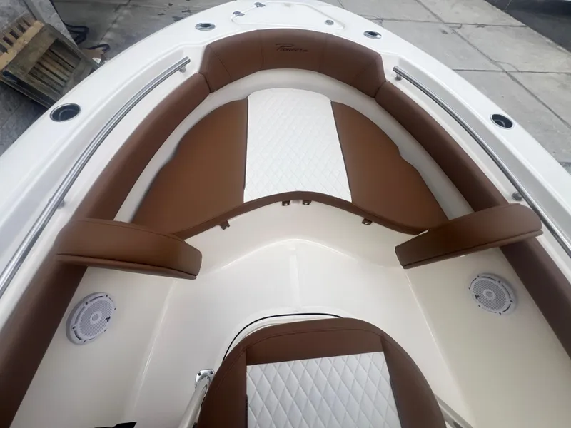 Slide: The Image of 2026 Pioneer 202 Islander boat interior with brown and white seating. - 19