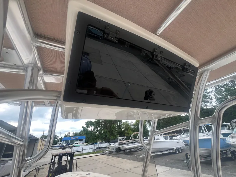 Slide: The Image of 2026 Pioneer 202 Islander boat with mounted display screen under canopy. - 23