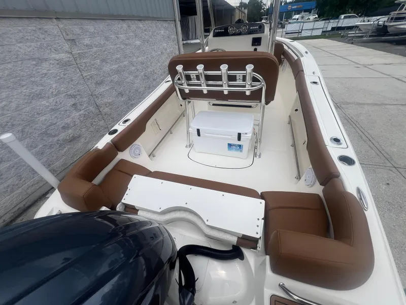 Slide: The Image of 2026 Pioneer 202 Islander boat interior with brown seating and fishing rod holders. - 4