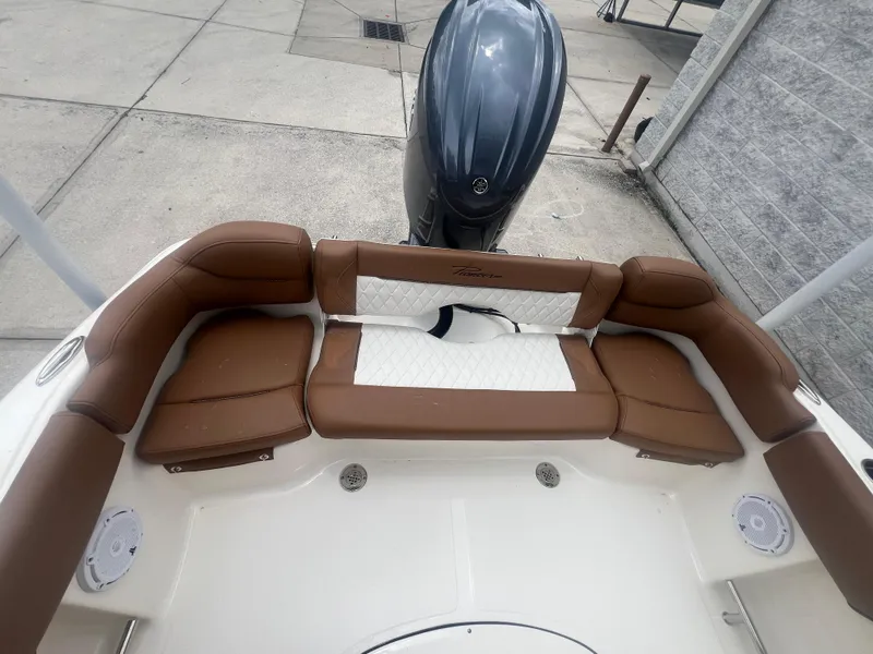 Slide: The Image of 2026 Pioneer 202 Islander boat interior with brown and white seating, outboard motor visible. - 5