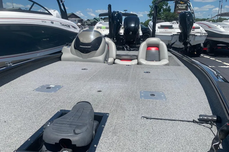 Slide: The Image of 2017 Tracker Pro Team 190 TX fishing boat with spacious deck and seating, displayed outdoors. - 4