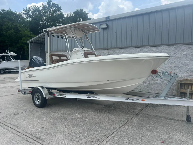 The Image of 2026 Pioneer 202 Islander boat on trailer, parked outdoors near a metal building. - 1