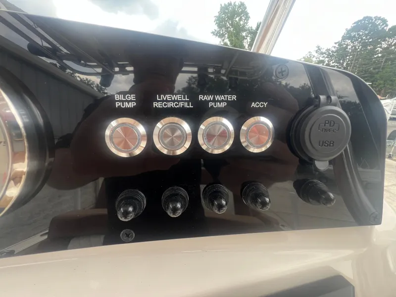 Slide: The Image of Control panel of 2026 Pioneer 202 Islander boat with pump switches and USB port. - 11