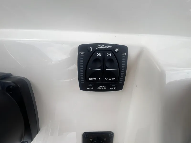 Slide: The Image of Trim tab control panel on 2026 Pioneer 202 Islander boat dashboard. - 13