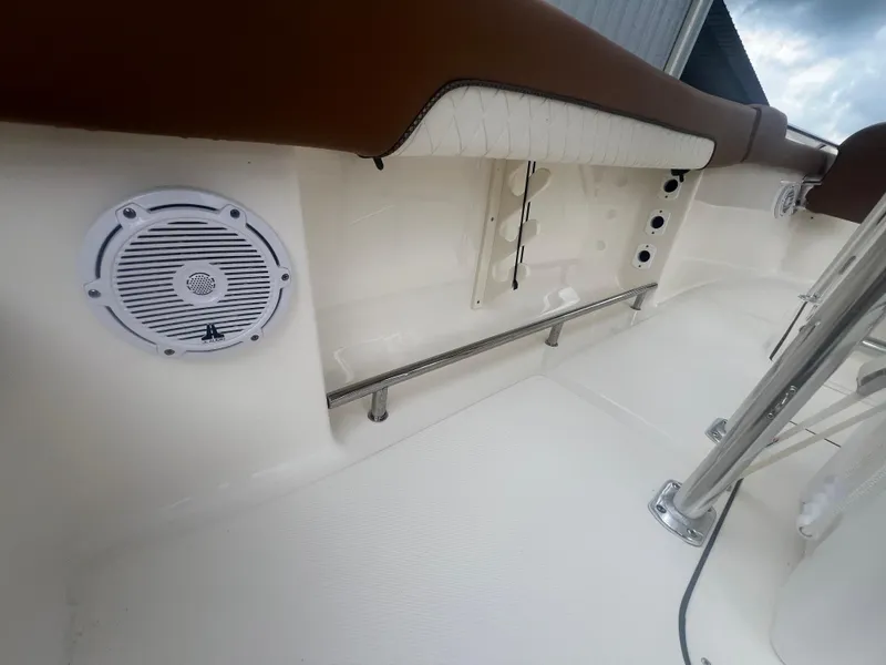 Slide: The Image of 2026 Pioneer 202 Islander boat interior with speaker and cushioned seating. - 21