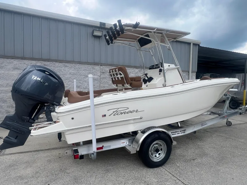 Slide: The Image of 2026 Pioneer 202 Islander boat on trailer with Yamaha outboard motor, parked outdoors. - 3