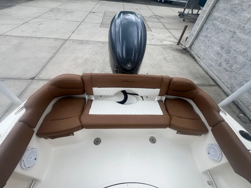 Slide: The Image of 2026 Pioneer 202 Islander boat with brown and white seating, outboard motor, and spacious deck. - 6