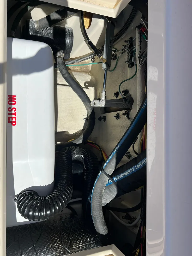 Slide: The Image of Engine compartment of 2025 Ranger Tugs R-29 CB with hoses and "No Step" warning. - 20