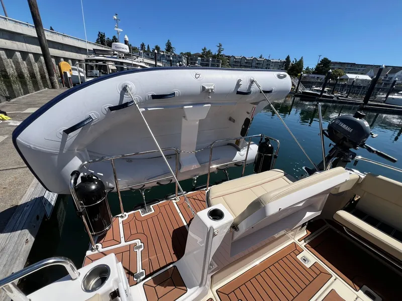 Slide: The Image of 2025 Ranger Tugs R-29 CB boat with inflatable dinghy and Yamaha motor at marina. - 38