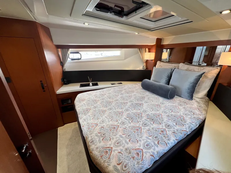Slide: The Image of Luxurious cabin interior of 2017 Jeanneau Velasco 43 yacht with elegant bedding and wood finishes. - 14